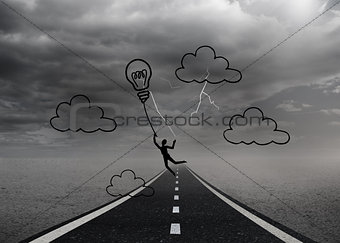 Light bulb balloon over street and stormy sky