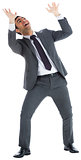 Scared businessman with arms raised