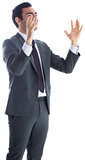 Stressed businessman with arms raised