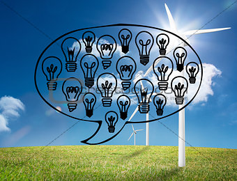 Light bulbs graphic on bright countryside with wind turbines