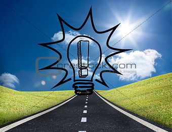 Light bulb graphic on bright countryside