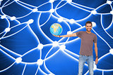 Composite image of man holding out a globe