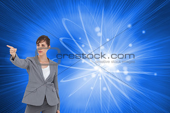 Composite image of businesswoman pointing to something