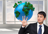Composite image of businessman holding and pointing