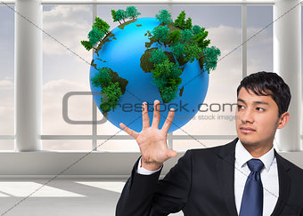 Composite image of businessman holding and pointing