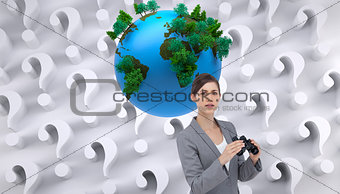 Composite image of young businesswoman posing with binoculars