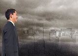 Composite image of businessman on digital city in the fog