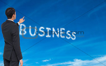 Composite image of  businessman pointing