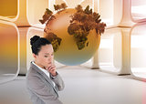Composite image of thinking asian businesswoman pointing