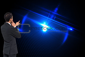 Composite image of thoughtful businessman pointing