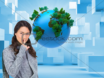 Composite image of model with winter clothes keeping secret