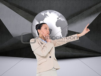 Composite image of thoughtful businesswoman pointing