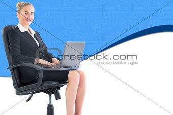 Composite image of businesswoman sitting in swivel chair with laptop