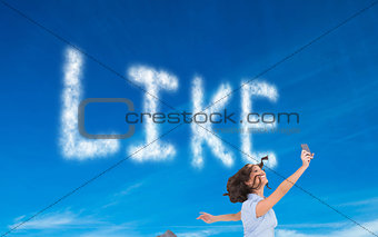 Composite image of happy businesswoman jumping while holding smartphone
