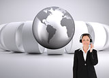 Composite image of woman in suit using headphones and posing