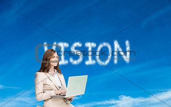 Composite image of businesswoman sitting and using laptop