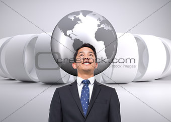 Composite image of businessman against grey abstract background
