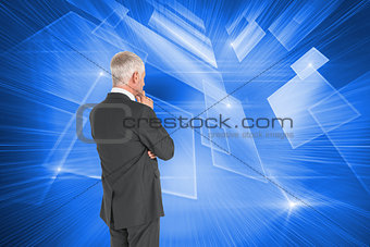 Composite image of businessman standing back to camera