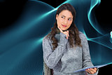Composite image of model wearing winter clothes holding her tablet