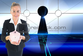 Composite image of businesswoman holding pink piggy bank