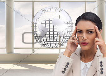 Composite image of businesswoman putting her fingers on her temples