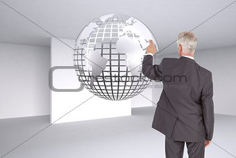 Composite image of rear view of mature businessman pointing finger
