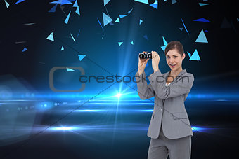 Composite image of businesswoman with binoculars
