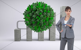 Composite image of businesswoman holding tablet pc