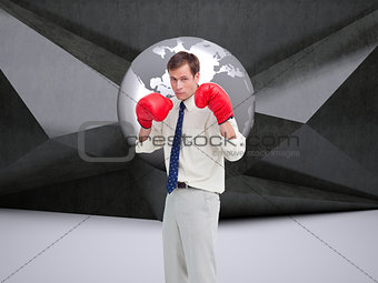 Composite image of businessman with his boxing gloves
