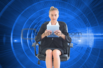 Composite image of front view of concentrated businesswoman using her tablet