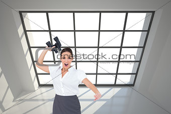 Composite image of businesswoman throwing binoculars away