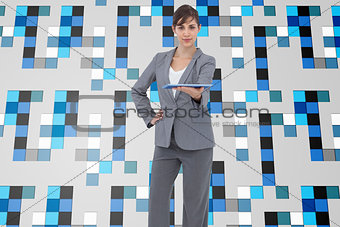 Composite image of businesswoman holding tablet pc