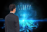 Composite image of businessman against technological blue light