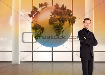 Composite image of businessman with crossed arms