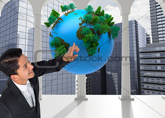 Composite image of smiling  businessman pointing