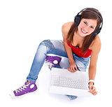 Smiling woman with headphones and laptop