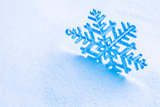 Snowflake on the snow. White xmas holiday background.