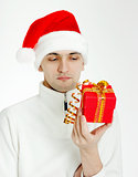 man in a Santa hat with Christmas gift