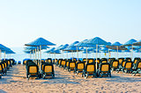 neat rows of sun loungers on the beach