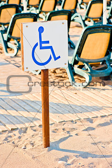 sign wheelchair set on the beach by the sea
