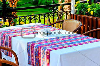 table covered with a tablecloth in a restaurant with Turkish ornament