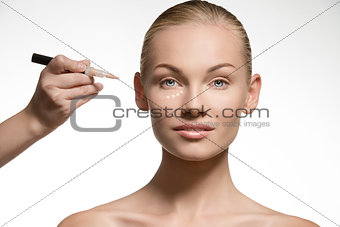 pretty girl preparing her skin for the make-up 
