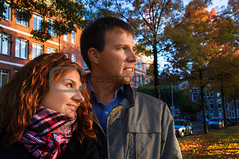 Outdoor happy couple in love posing against autumn Amsterdam bac