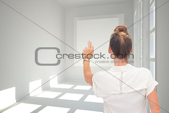 Composite image of businesswoman touching something
