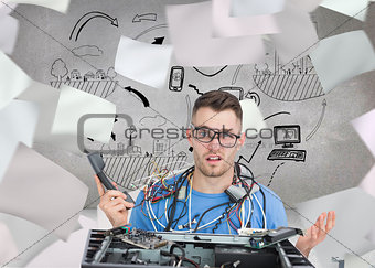 Composite image of confused it professional with cables and phon