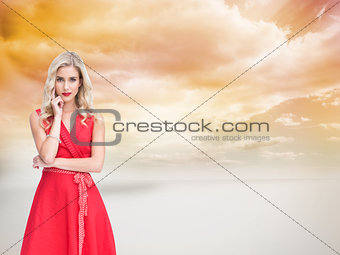 Composite image of thoughtful blonde wearing red dress