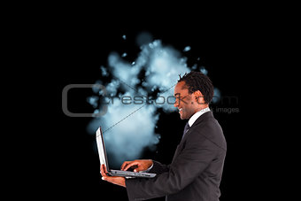 Composite image of businessman working on laptop 