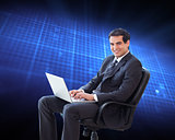 Composite image of young businessman sitting on an armchair work
