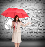 Composite image of happy businesswoman holding umbrella