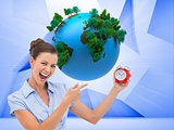 Composite image of businesswoman indicating alarm clock